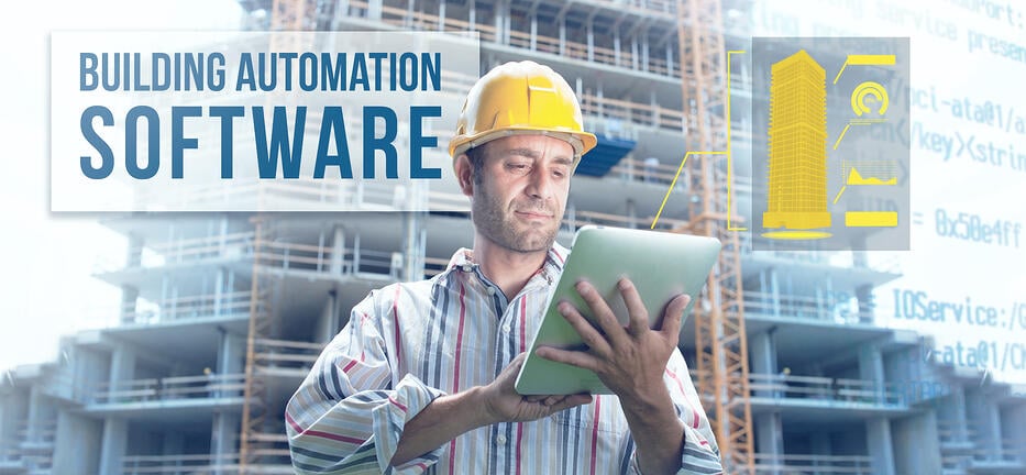 Construction worker with tablet in front of building under construction