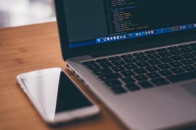 laptop computer and mobile phone on tabletop