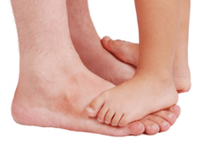 Childs feet on top of parents feet